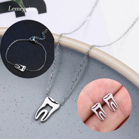 This stainless steel jewelry set, including necklace, earrings, and bracelet, is a must-have item for the passionate dentist or medic. With its classic style and durable metal material, it's perfect for any party and suitable for both men and women. The unique tooth design adds a touch of personality and the perfect amount of inspiration to any outfit. Don't miss out on this fashionable and fine quality set!   