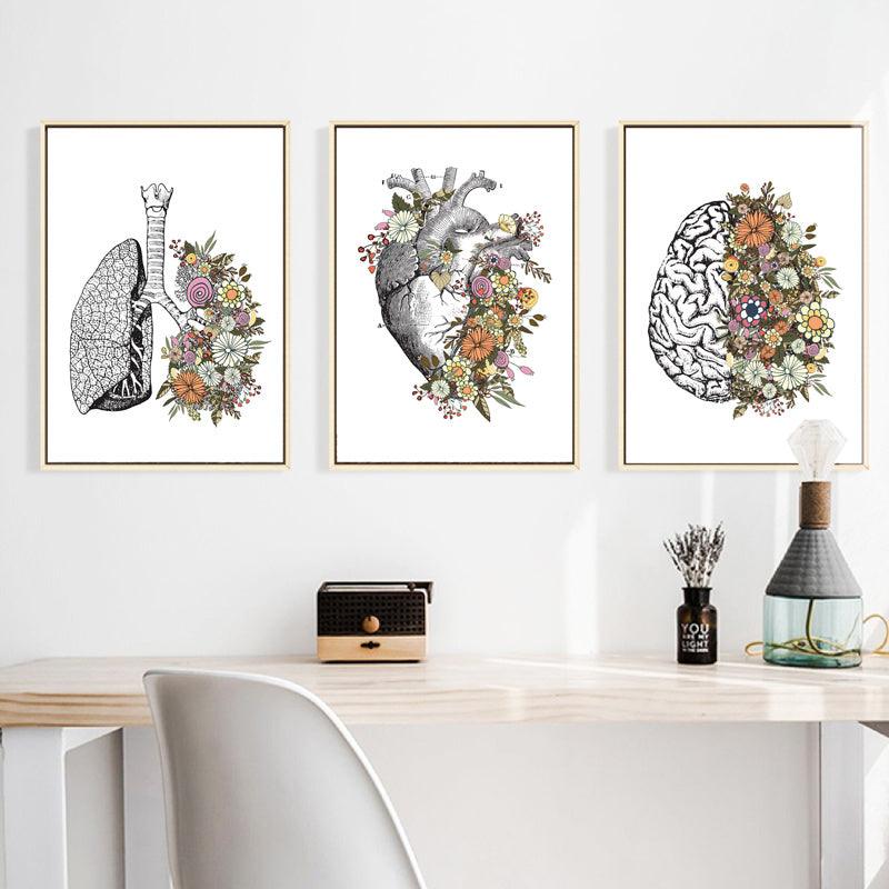 Featuring our set of three vintage canvas prints with an abstract representation of the human brain, heart, and lungs in a unique blend of anatomy and floral elements.